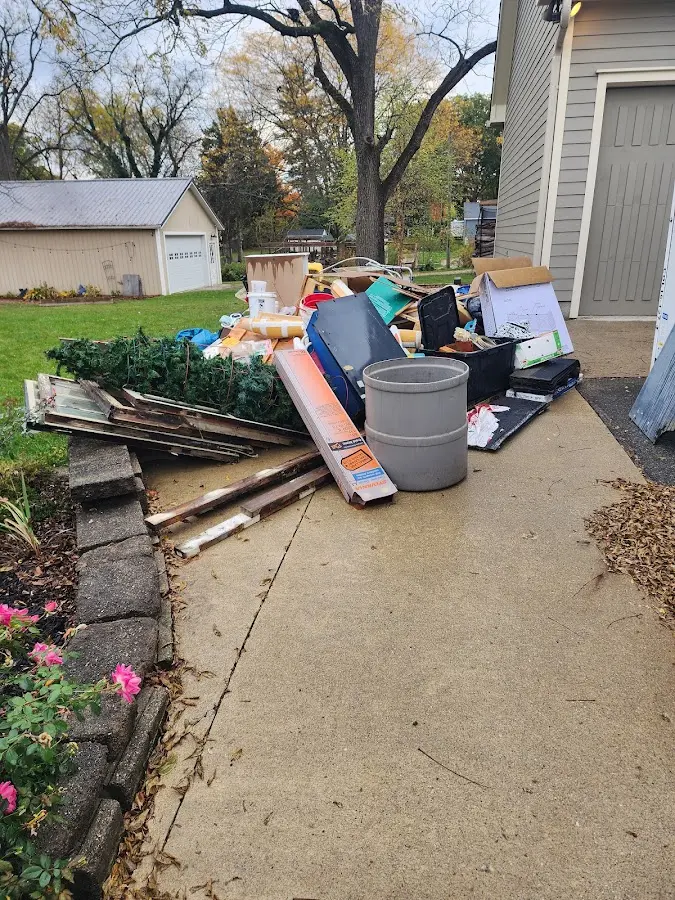 Dumpster being loaded with debris for 10 Yard Dumpster Rental in North Druid Hills